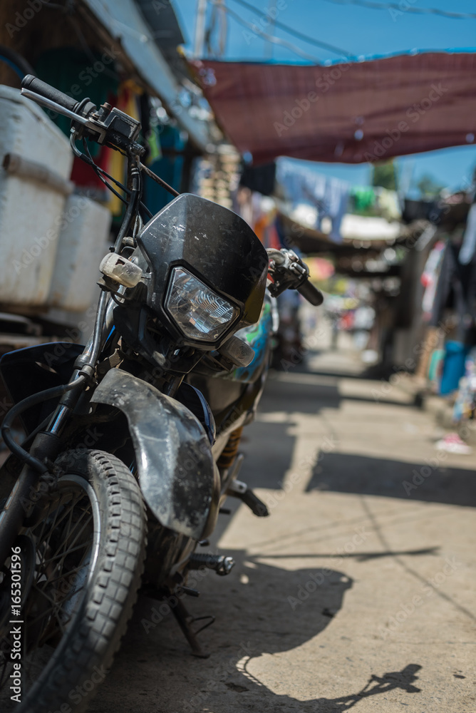 A lonely bike in an ally among the shacks A lonely bike in an ally among the shacks