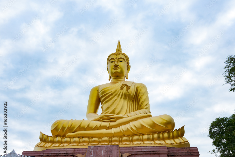 Golden Buddha images on sky clouds background.Golden Buddha statue in a Buddhist temple Golden Buddha images on sky clouds background.Golden Buddha statue in a Buddhist temple