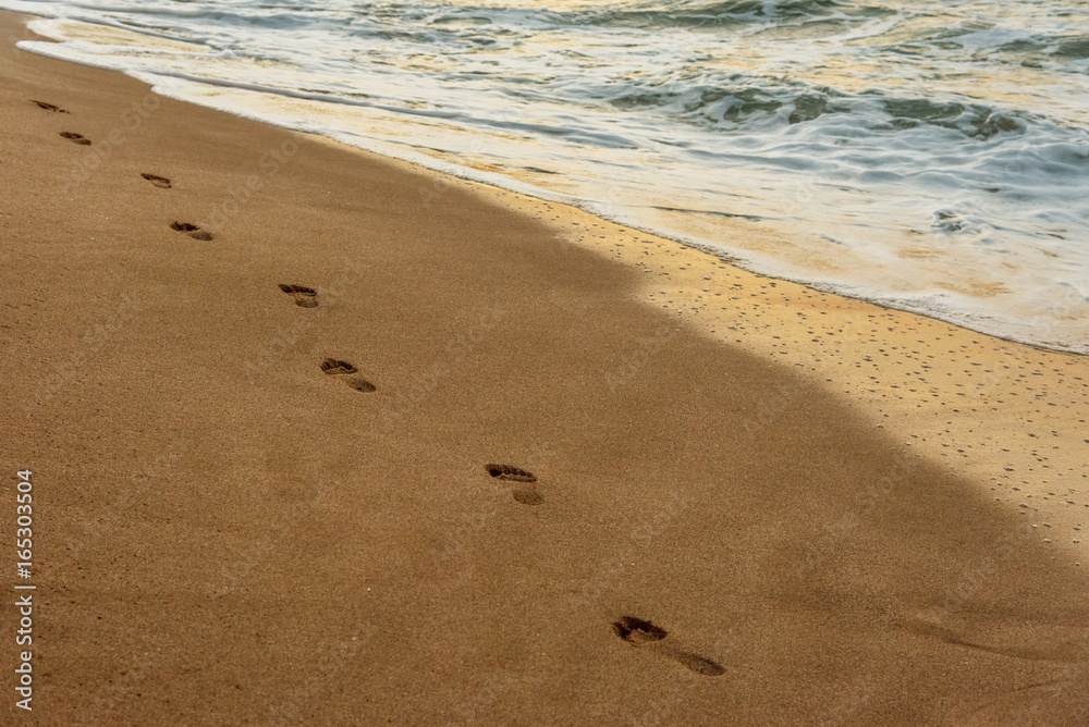beach, wave and footsteps at sunset time beach, wave and footsteps at sunset time