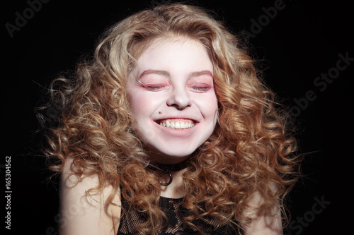 Portrait of young girl bursts out laughing