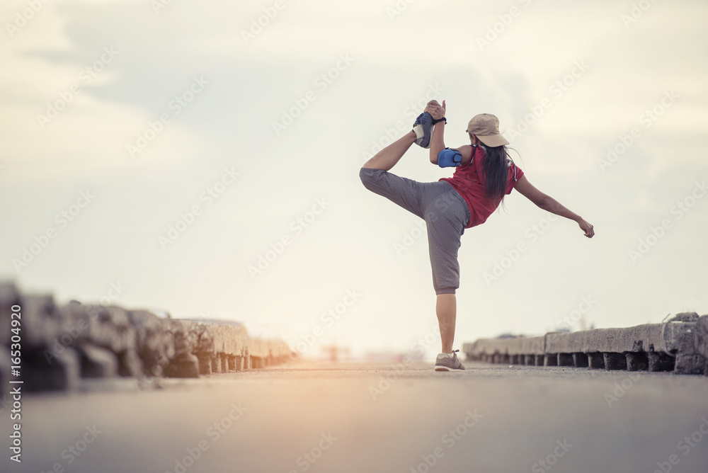 Young healthy woman practicing yoga on the beach at sunrise Young healthy woman practicing yoga on the beach at sunrise