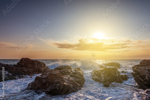 Splashes of wave at sunrise. © ba11istic