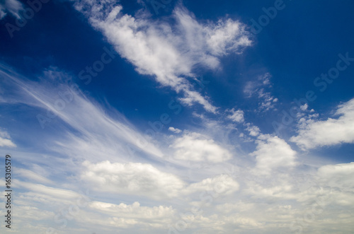 White clouds in deep blue summer sky, natural sky background
