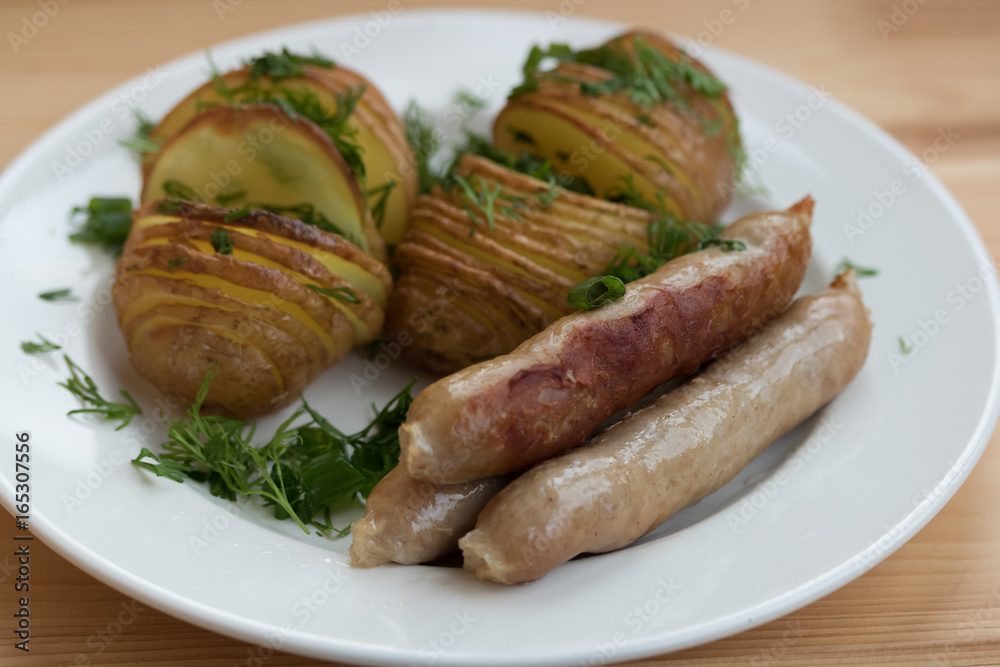 Potatoes with sausages on the grill with herbs Potatoes with sausages on the grill with herbs