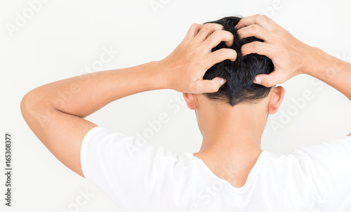 Young man suffering from itching her head, Itching scalp.