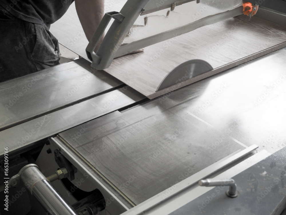 Cut the parts from chipboard on a circular saw at a furniture factory