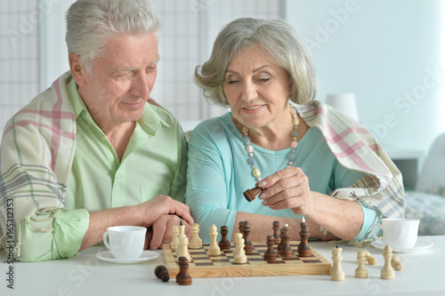 senior couple playing chess