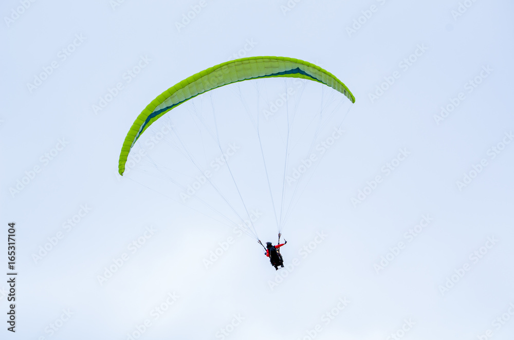 Colorful hang glider/paraglider against the blue sky Colorful hang glider/paraglider against the blue sky