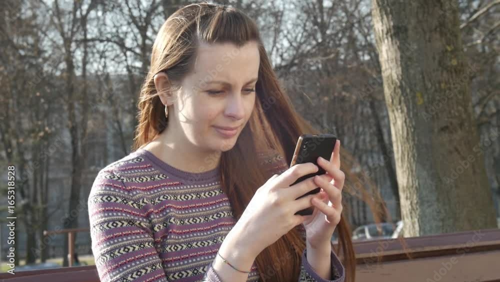 Woman hand touching screen on modern mobile smart phone