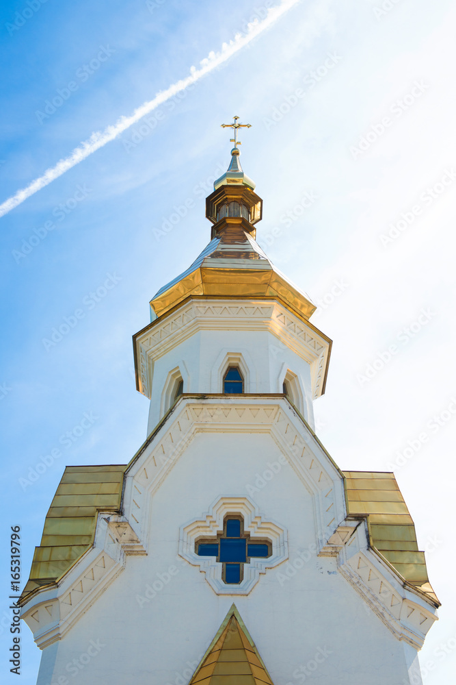 Golden domes of the church against the sky.
