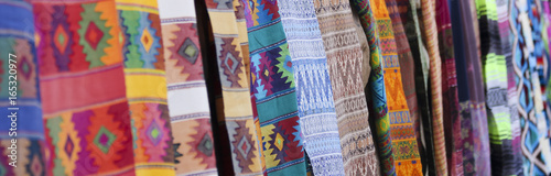 An Assortment of Colorful Blankets Hanging in a Row photo