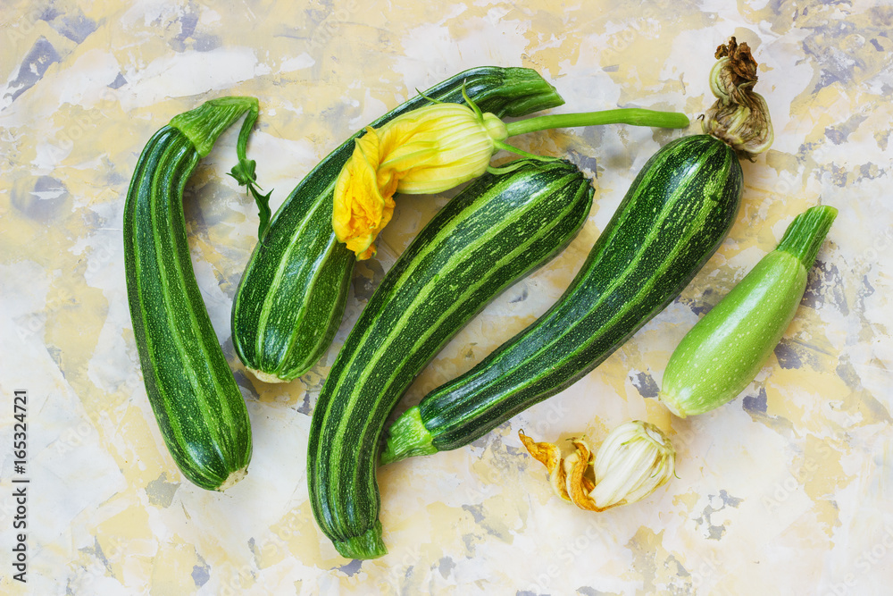 Fresh zucchini on wicker mat on Light background Fresh zucchini on wicker mat on Light background