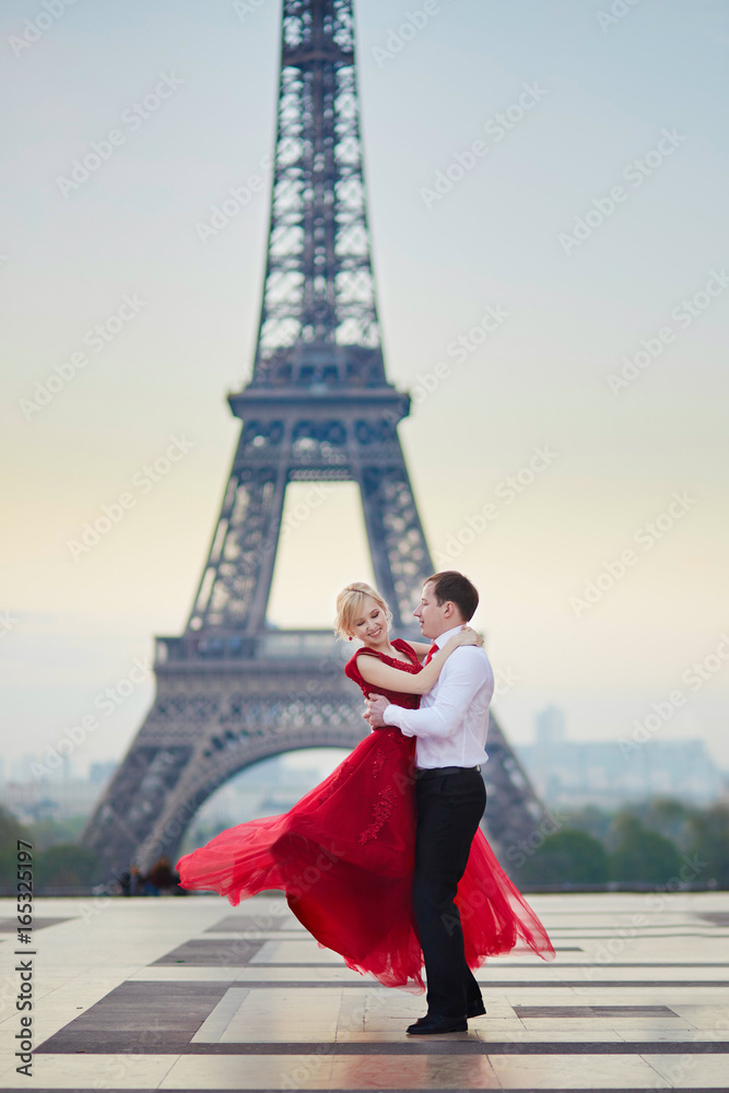 Couple dancing in front of the Eiffel tower in Paris, France