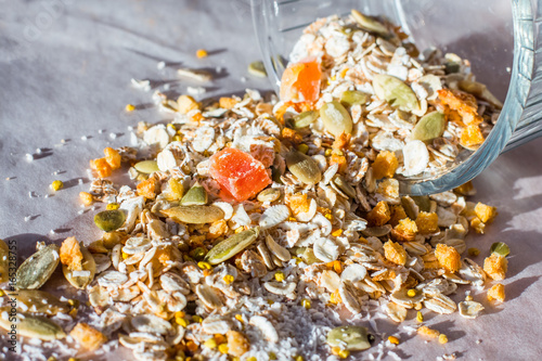 Plate of homemade muesli with pumpkin seeds, flower dust, candied fruit, freeze dried apricot