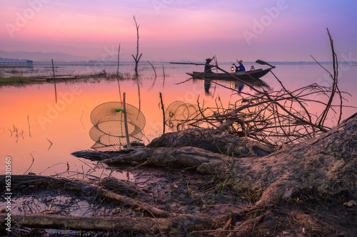 Fishermen are out to fish in the reservoir early in the morning.