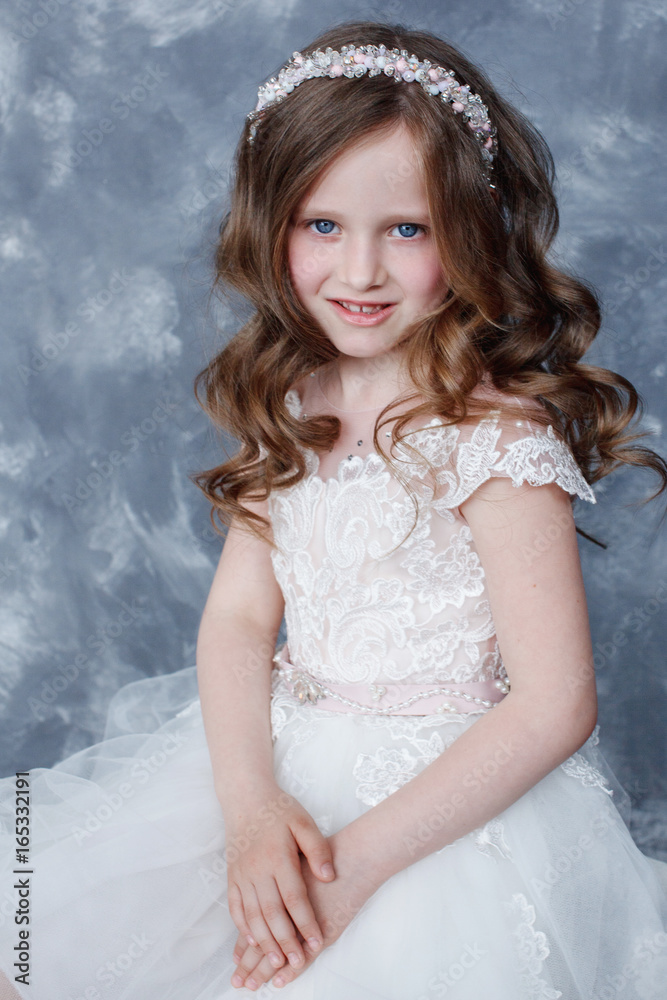 Beautiful little girl in a dress with a train, horizontal frame. Beautiful little girl in a dress with a train, horizontal frame.