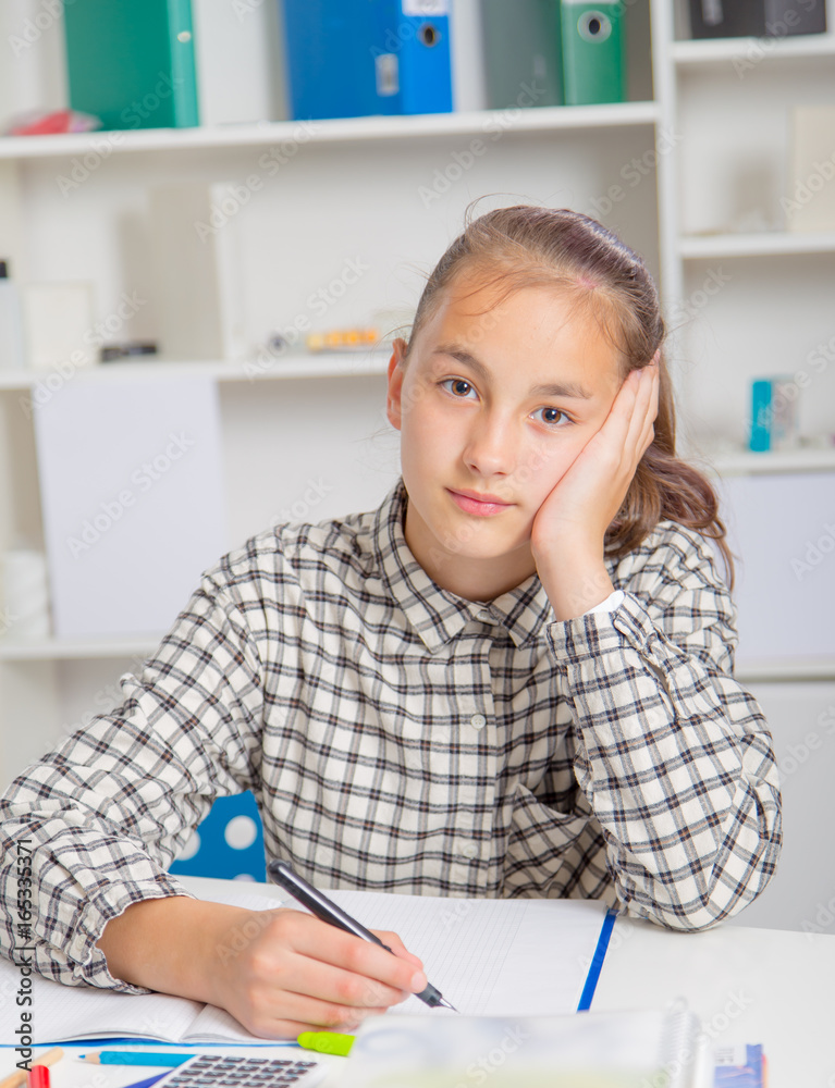 Teenage girl preparing for exams. Teenage girl doing homework for school. Teenage girl preparing for exams. Teenage girl doing homework for school.