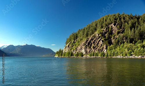 View at the cliff and mountain ridge in Porteau Cove,  coastline and forest. British Columbia Canada. photo