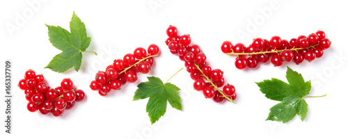 Ripe and juicy red currant with leaves isolated on white background, top view photo