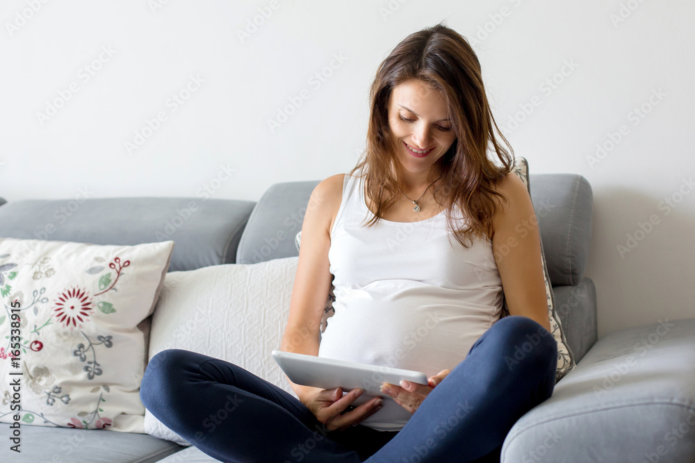 Young pregnant woman, having painful contraction, starting labor Young pregnant woman, having painful contraction, starting labor
