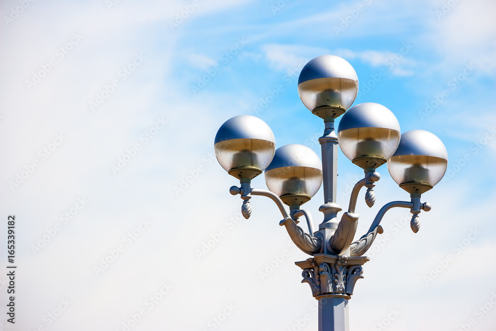 Beautiful street lamp on a background of blue, little cloudy sky Beautiful street lamp on a background of blue, little cloudy sky