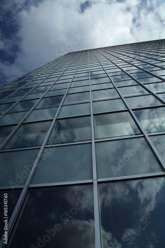 The sky is reflected in the skyscraper windows