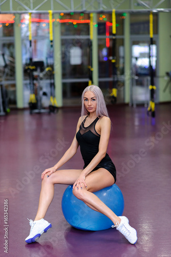 Beautiful girl on a fitball in the gym. © fotofrol