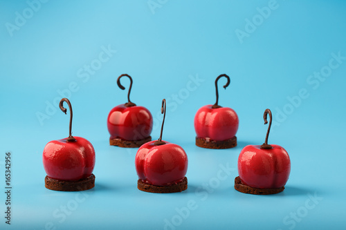 Glossy mousse cakes in the form of cherries photo