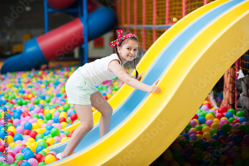 Little girl playing with colorful balls