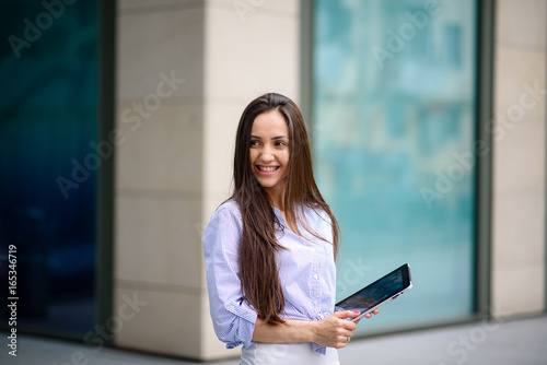 Beautiful girl smiling and running on a tablet.
