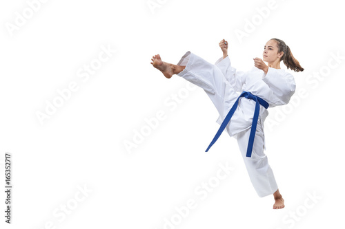 On a white background the sportswoman beats a kick leg