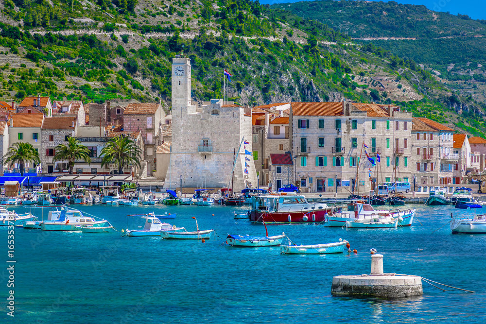 Naklejka premium Komiza town seafront. / Seafront view at coastal town Komiza in south of Croatia, Island Vis.