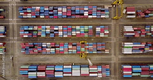 JAKARTA, Indonesia. July 10, 2017: Top view footage of cargo containers with crane and truck in Tanjung Priok port. Shot in 4k resolution photo