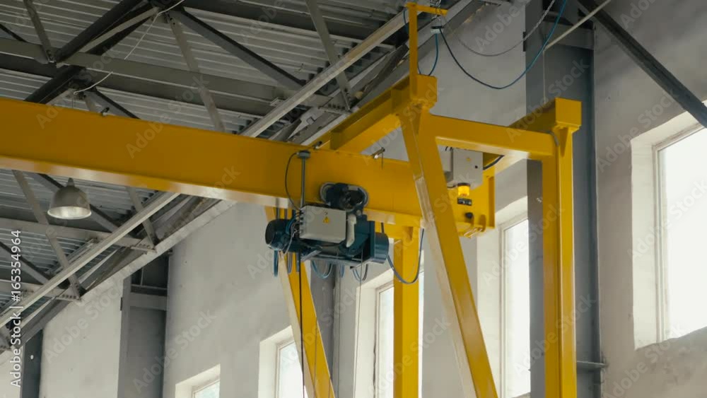 Overhead crane moves in large workshop