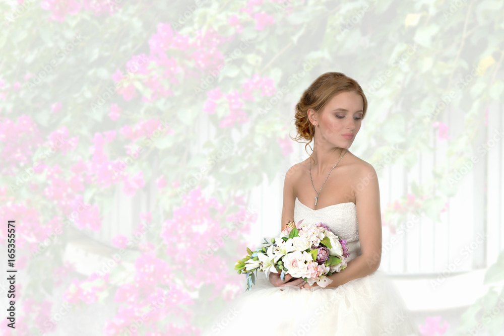 the bride with a bouquet against the background of flowers the bride with a bouquet against the background of flowers