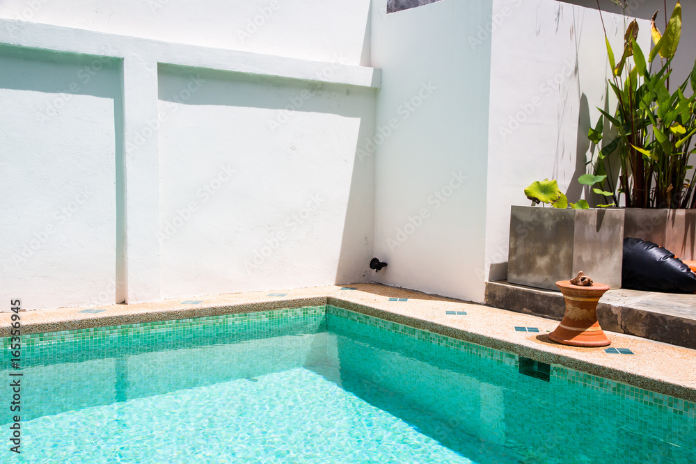 Fototapeta premium Modern backyard of a swimming pool with clear water