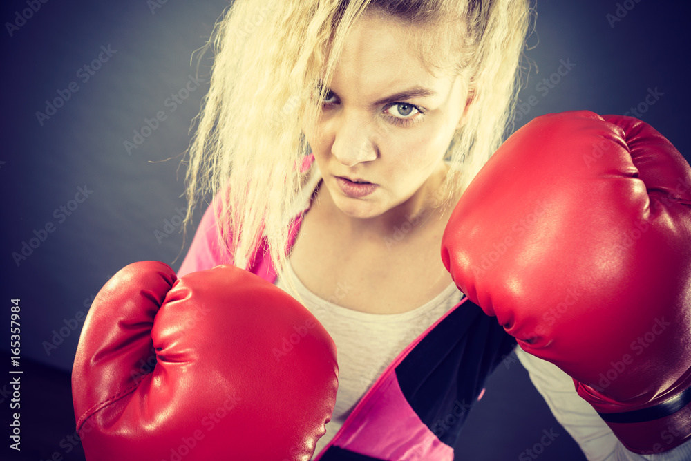 Angry woman wearing boxing gloves Angry woman wearing boxing gloves