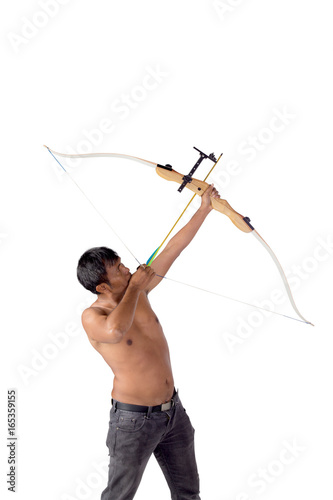 Asian man holding bow and shooting to archery target. Rear view, businessman aiming at target with bow and arrow, target success concept.