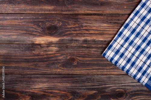 blue checkered tablecloth on the black wooden table with copy space for your text. Top view