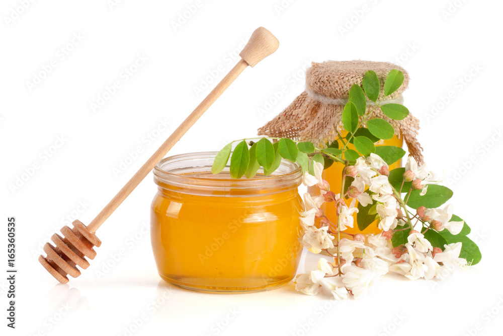 Jar of honey with flowers of acacia isolated on white background Jar of honey with flowers of acacia isolated on white background