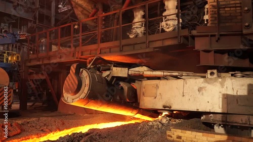 Metallurgical plant, hot metal casting. Machine taphole ramming. Metallurgical equipment photo