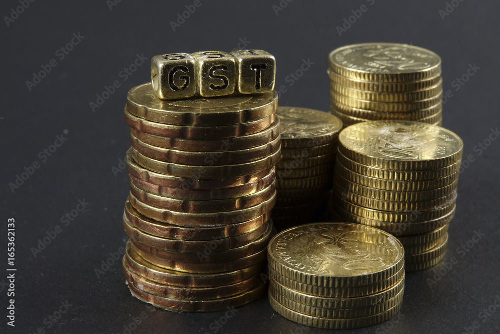 Stack of coins and GST word. Business and taxation concept. Stack of coins and GST word. Business and taxation concept.