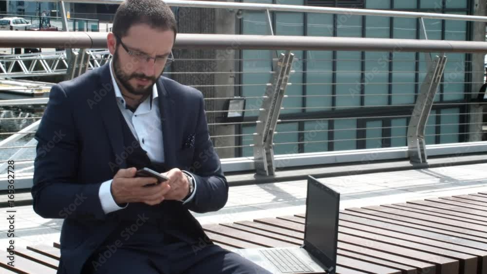 Criminal With Mask Stealing A Laptop From A Businessman While He Talks On A Mobile. Criminal With Mask Stealing A Laptop From A Businessman While He Talks On A Mobile.
