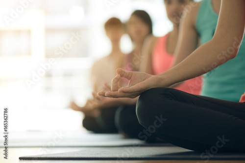 Young women yoga indoors keep calm and meditates while practicing yoga to explore the Inner Peace. Yoga and meditation have good benefits for health. Photo concept for Yoga Sport and Healthy lifestyle
