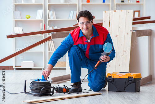 Young carpenter working with wooden planks