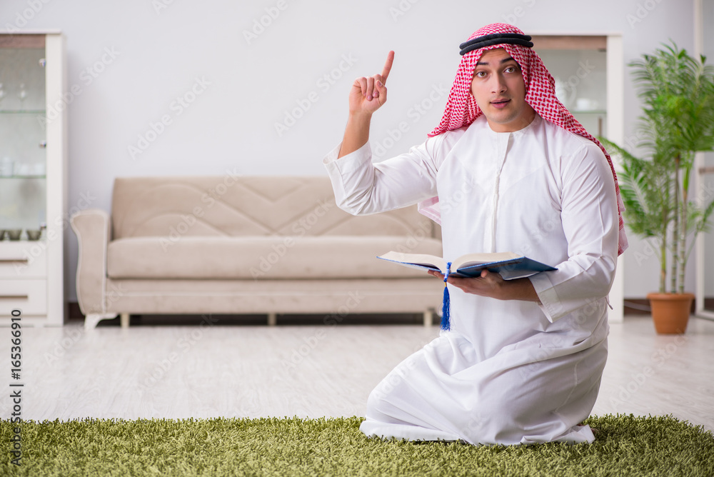 Fototapeta premium Arab man praying at home