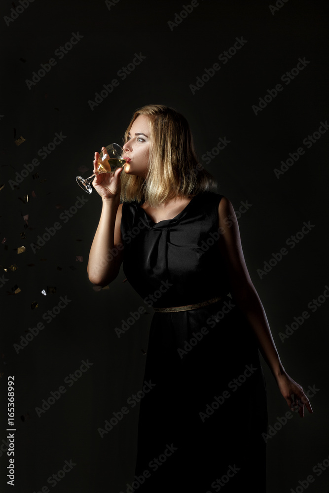 Beautiful blonde woman with glass of white wine on black background Beautiful blonde woman with glass of white wine on black background