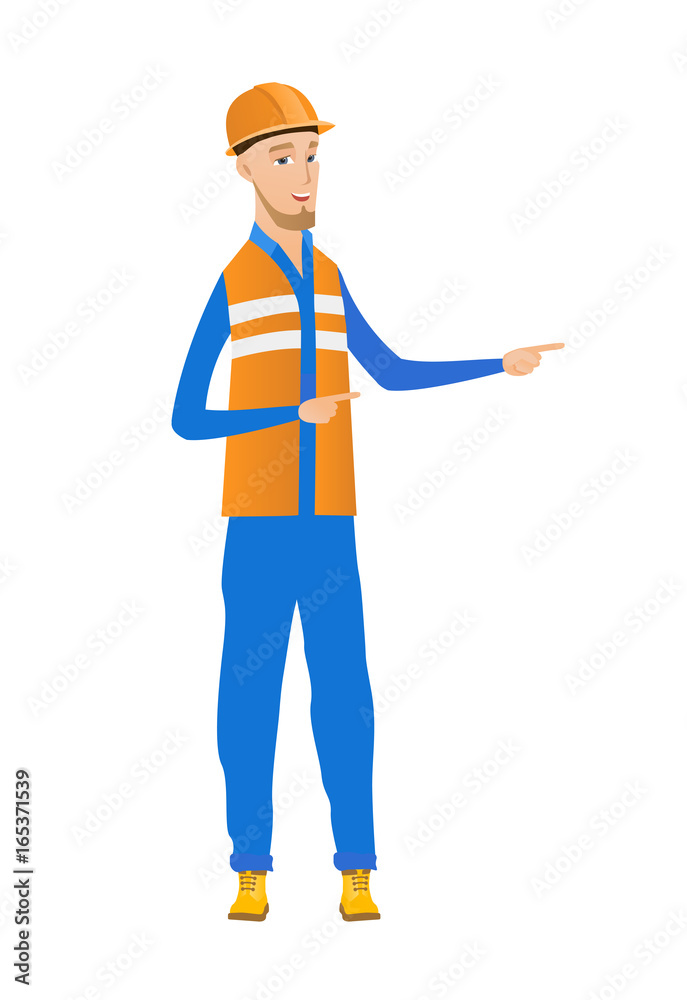 Young caucasian builder pointing to the side. Young caucasian builder pointing to the side.