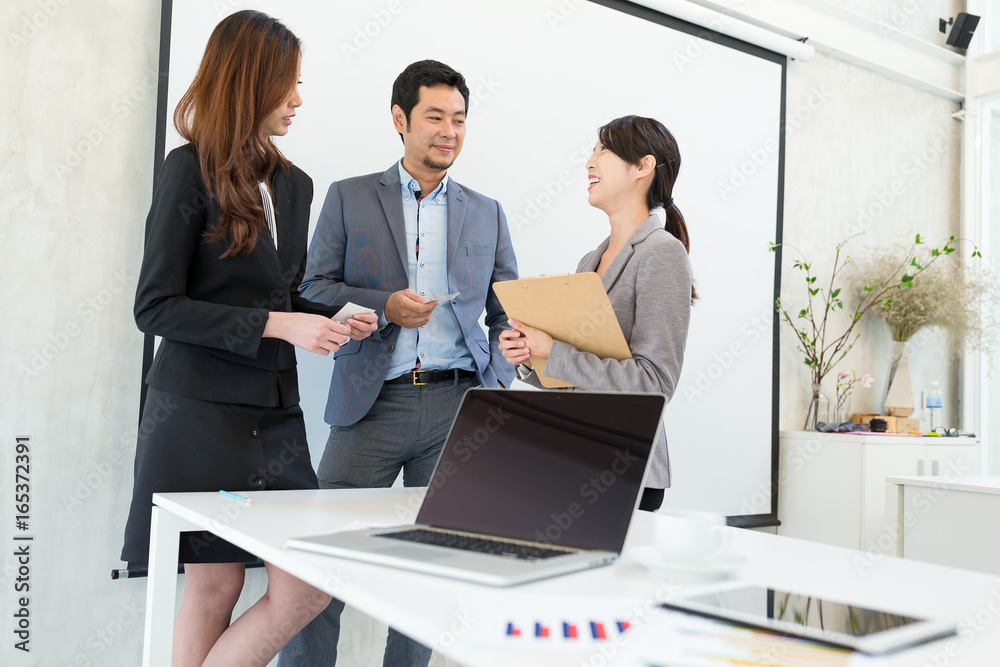 Business people talking to each other in office Business people talking to each other in office