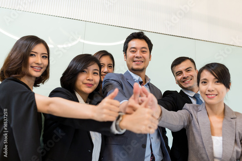 Fotografija Business people showing thumb up